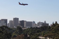 Airplane over San Diego skyline